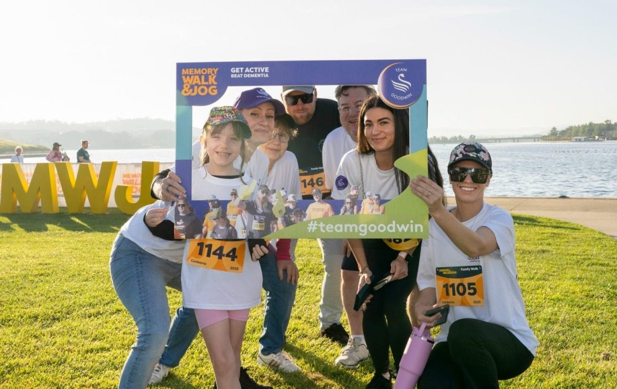 Memory Walk & Jog participants holding a photo frame outdoors