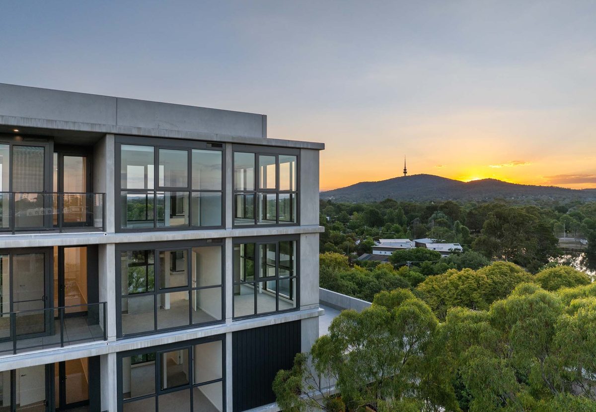 modern apartment building with surrounding greenery and sweeping views