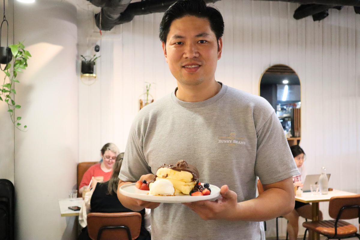 Man holding a plate of pancakes