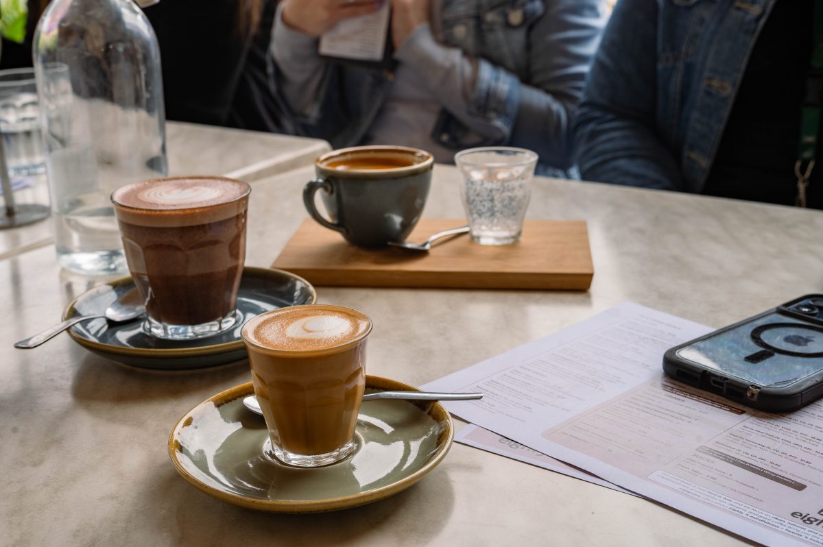 several hot drinks sit on a table