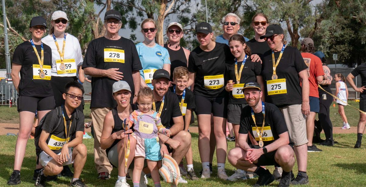 big group of runners posing after fun run