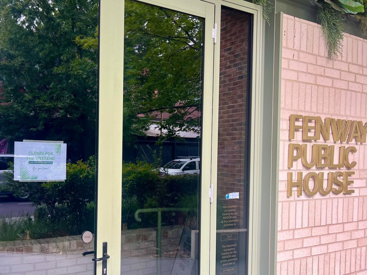 The entrance to Fenway Public House. There is a sign on the door that reads 'closed for the weekend'.