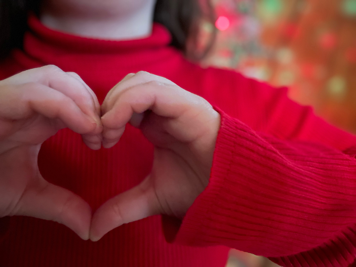 girl making heart shape