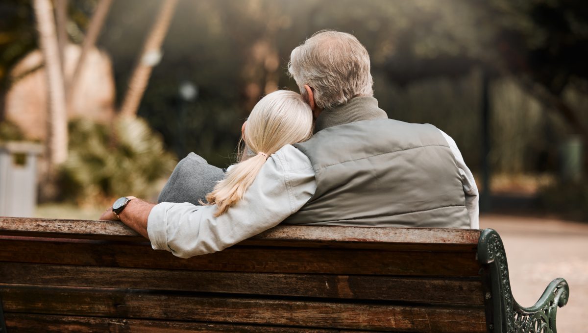 two people sitting together on a bench
