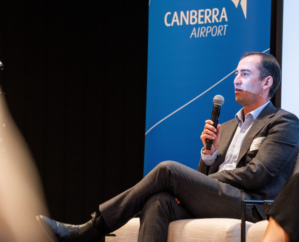 man speaking at a forum