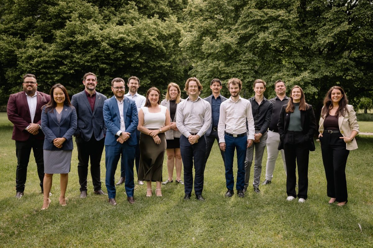 group of people standing on grass