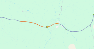 Man dies after car slides down embankment, highway closed