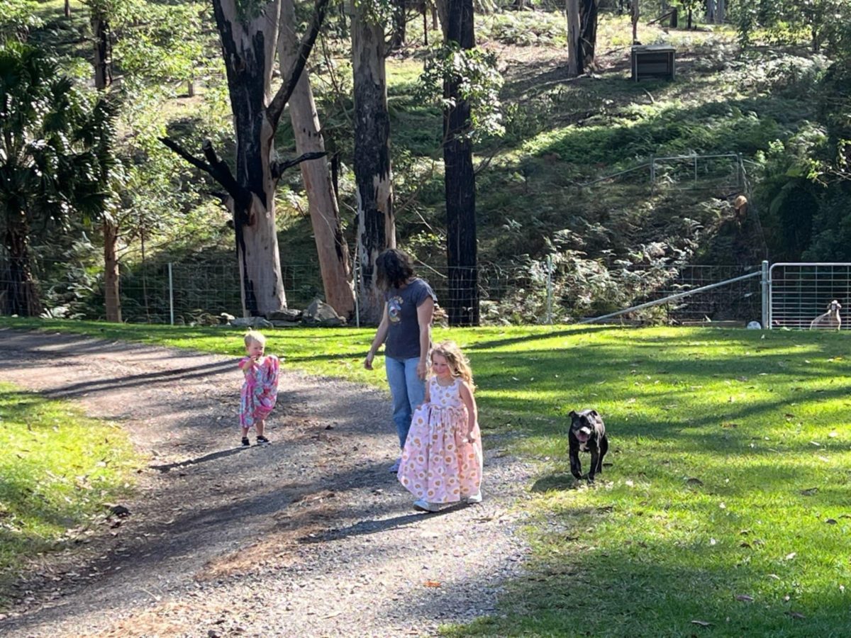A couple of kids and a little black dog.