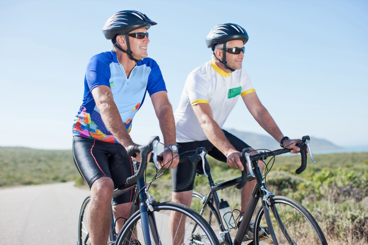 two men riding bicycles in remote area
