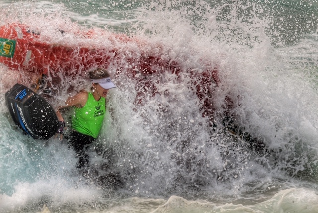 Wave crashing over surfboat