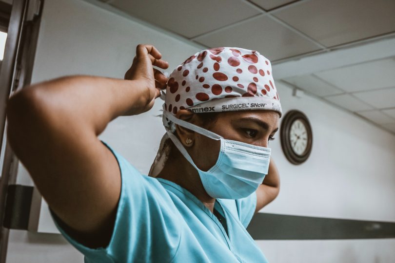 Nurse applying face mask.