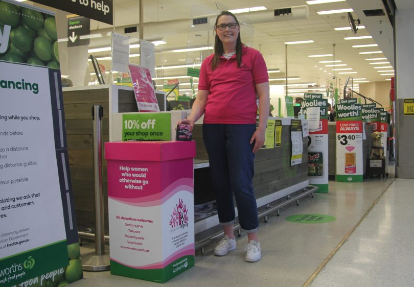 Share the Dignity ACT volunteer Angela McCaughey donates period pads at a Woolworths collection point.