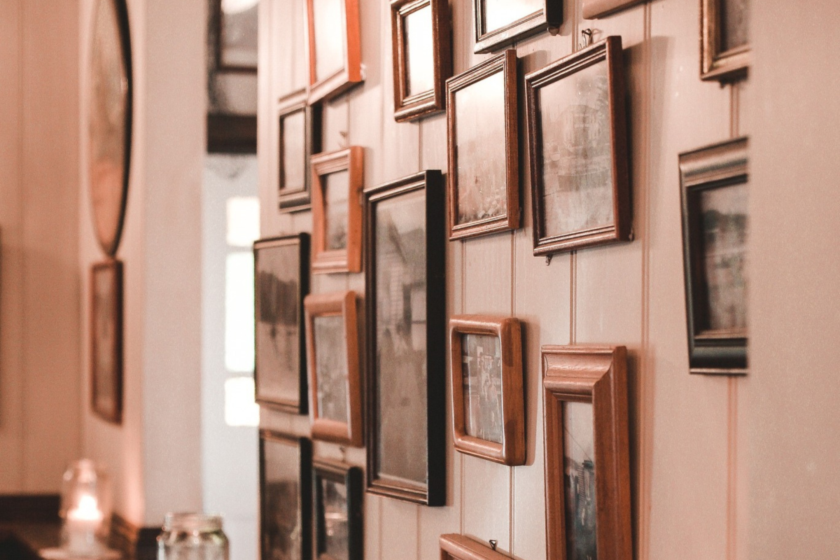 Many picture frames on a wall