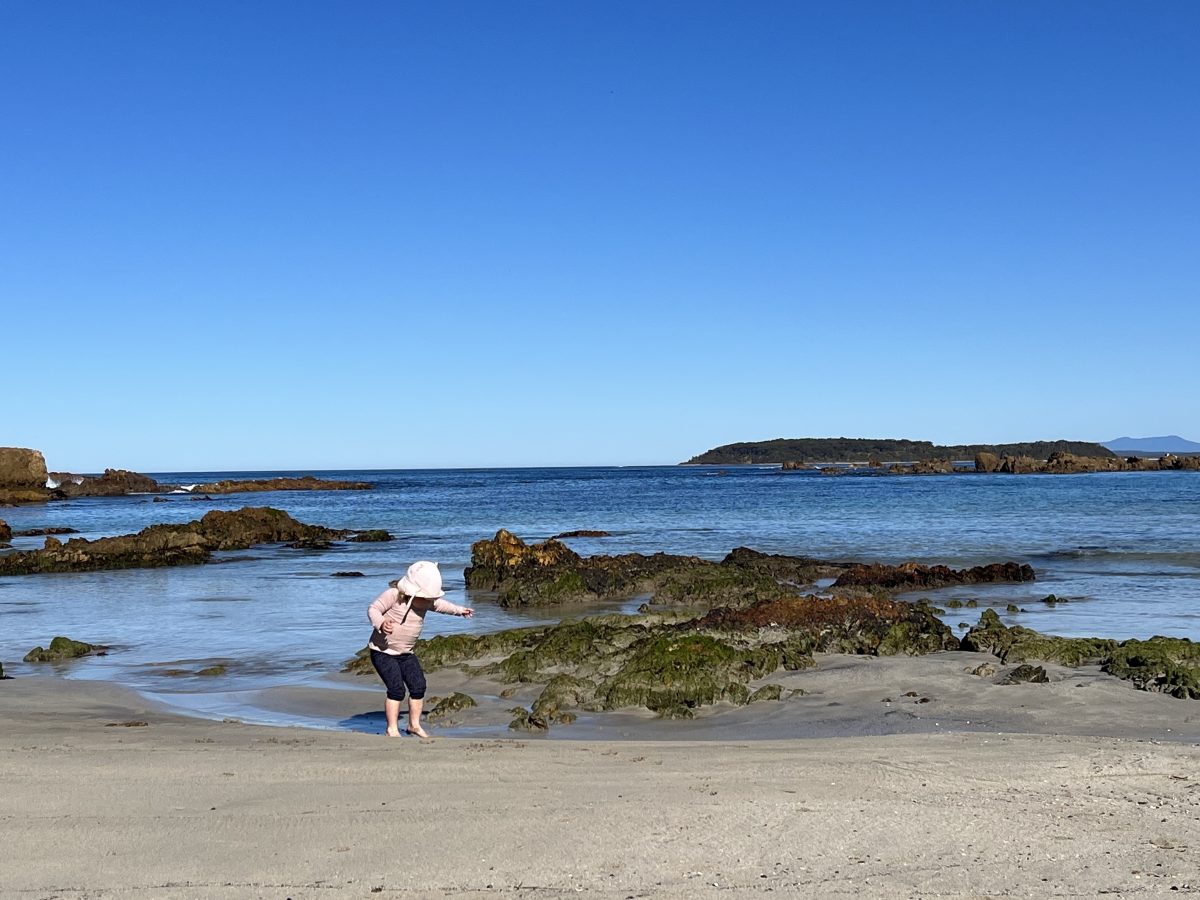 child playing on South Coast beach