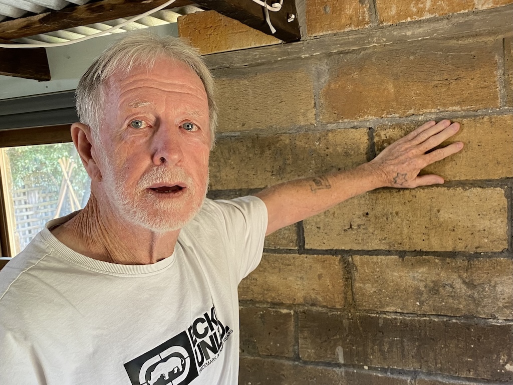 Michael with some of the bricks he made in his Goulburn backyard and coloured, for his man cave.