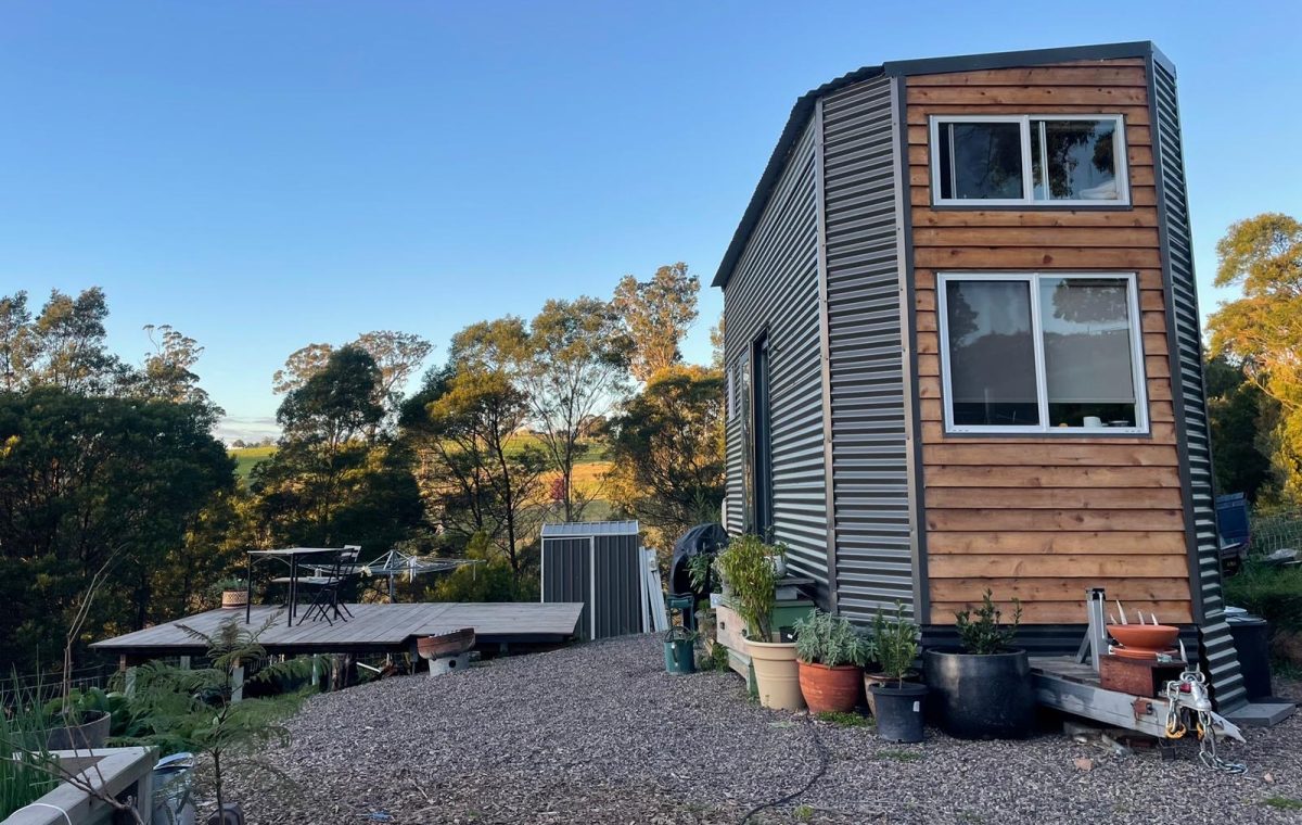a tiny house on a trailer on a farm