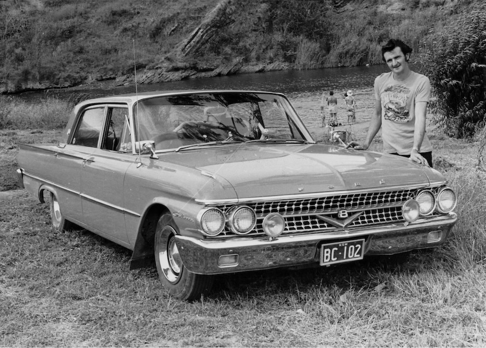 man and a car in the 1970s