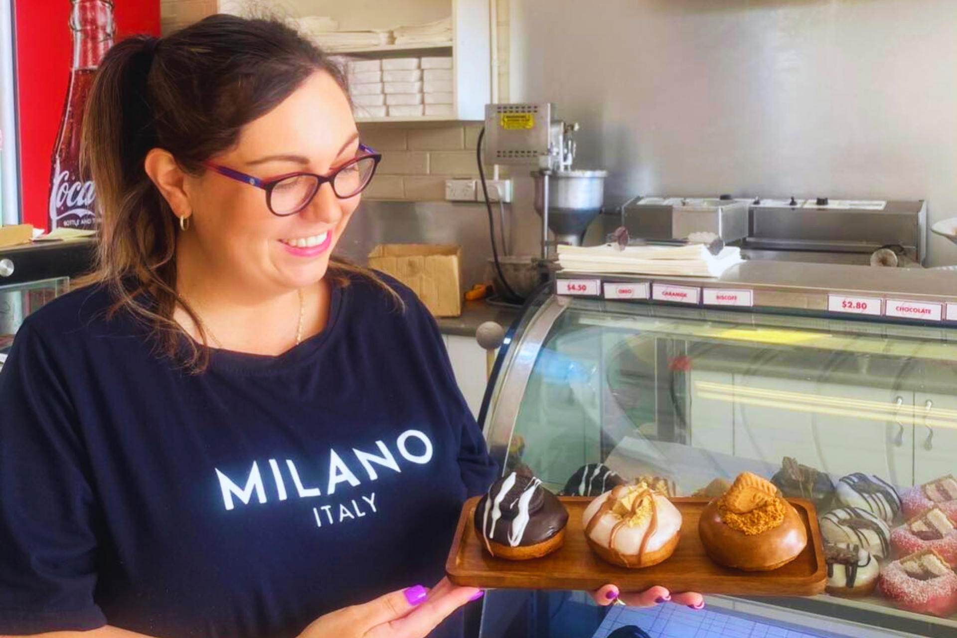 Woman holding donuts.