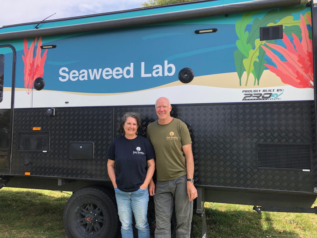 a woman and a man at a mobile seaweed lab