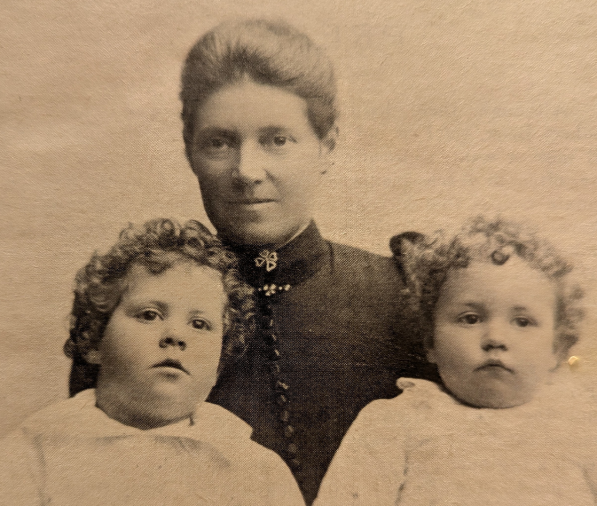 Vintage black-and-white photo of a woman and two children