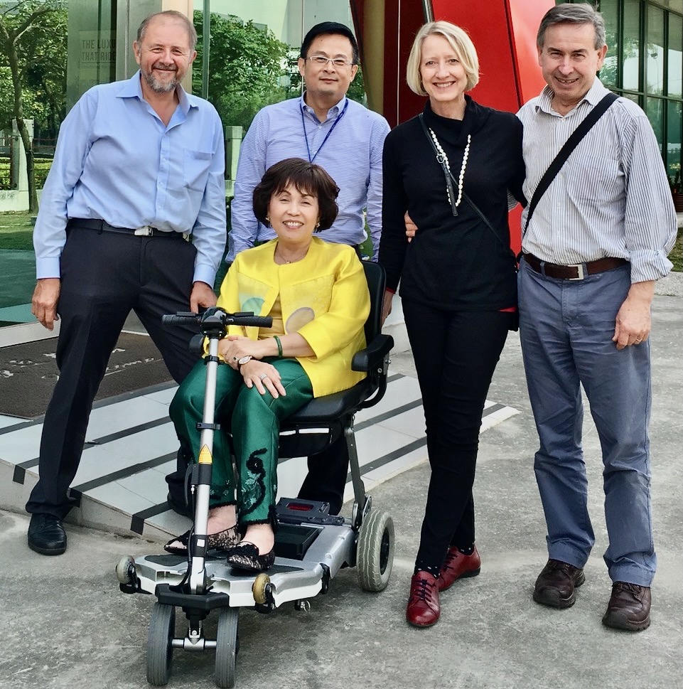 group of people, including a woman in a mobility scooter