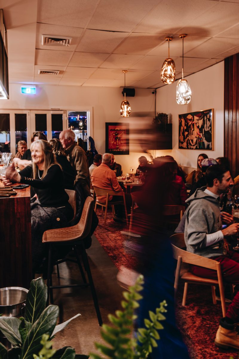 Bustling busy bar full of people.