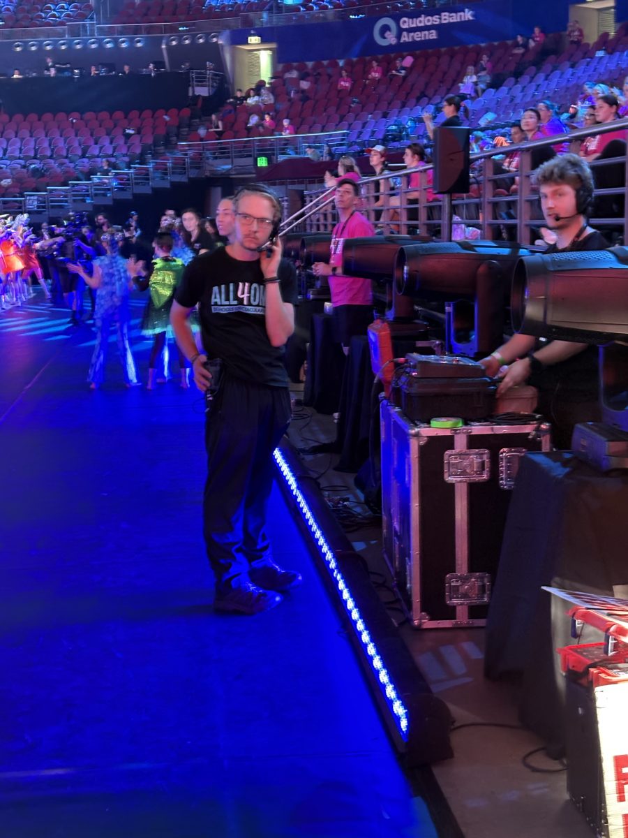 People with headstets inside a stadium as part of a pyrotechnics team during a show