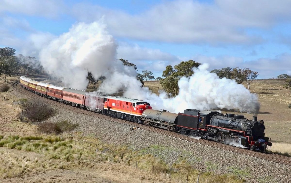 Approaching Yarra near Goulburn the Picnic Train has a little help from a diesel locomotive, but dominates the landscape with its trail of steam.