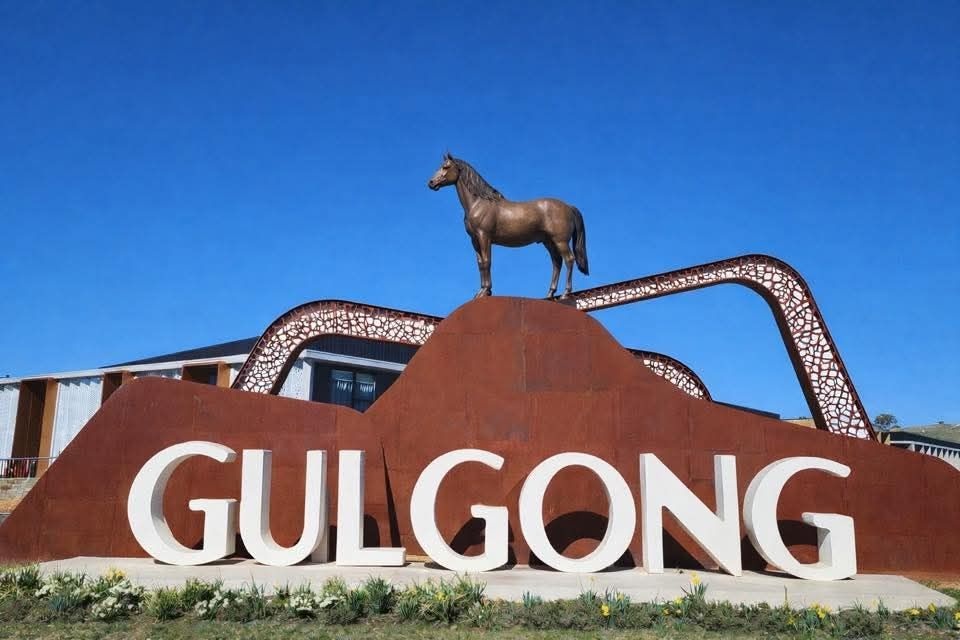altered town sign with a horse on top