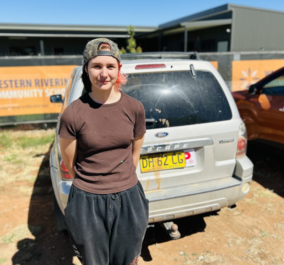 Charlie in front of car